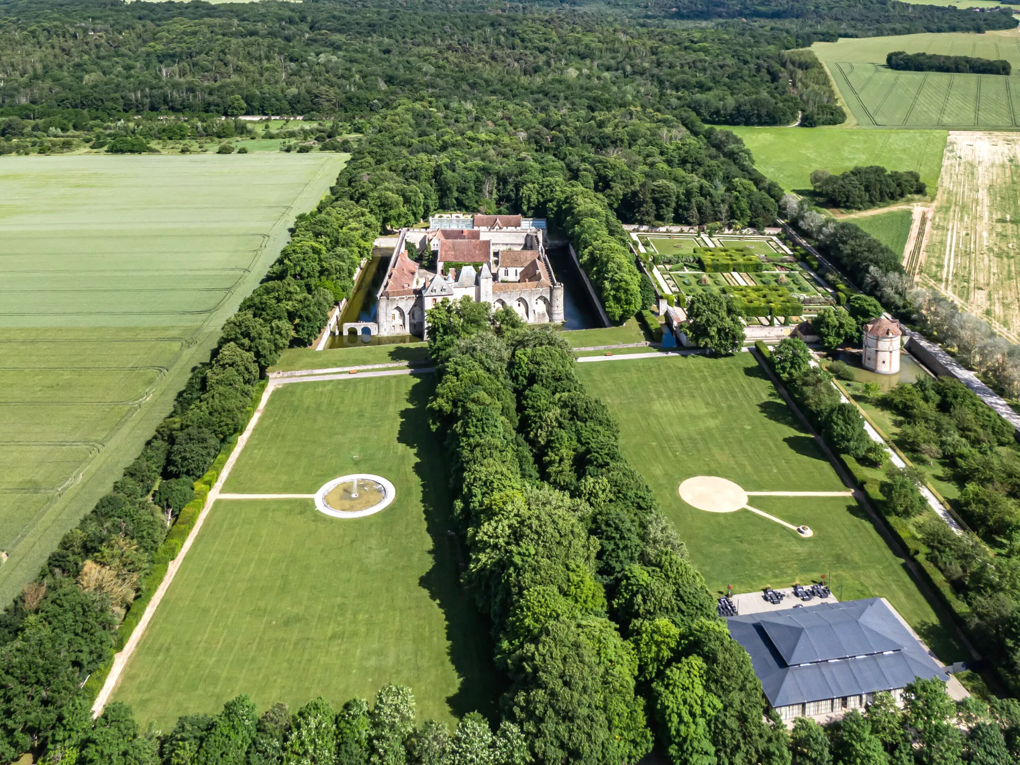 The estate from the air: château, moat, gardens and park