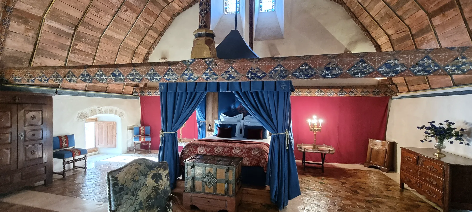 A blue bedroom in the château, bed and armchairs
