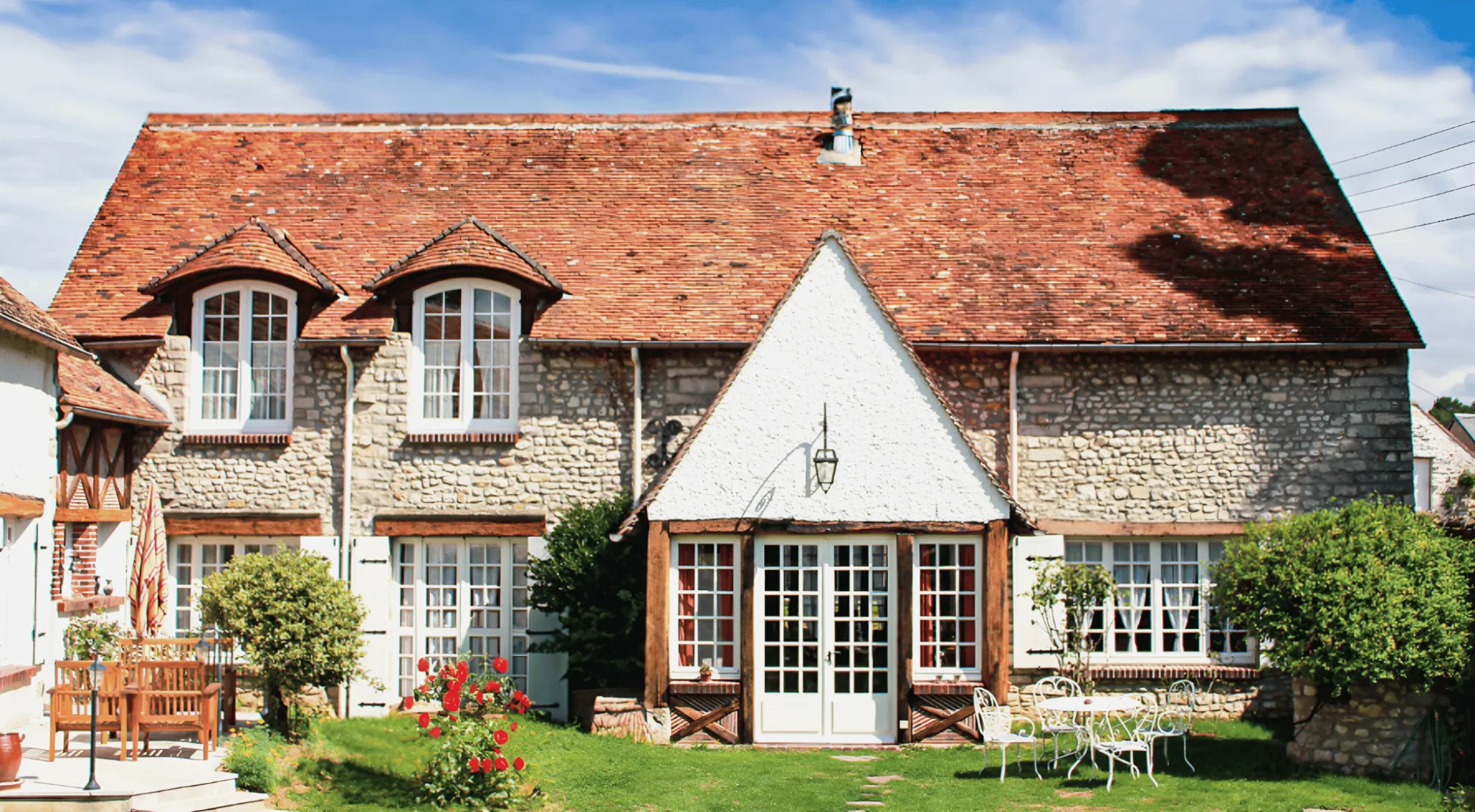 The gîte from its garden, its stone front and white gable
